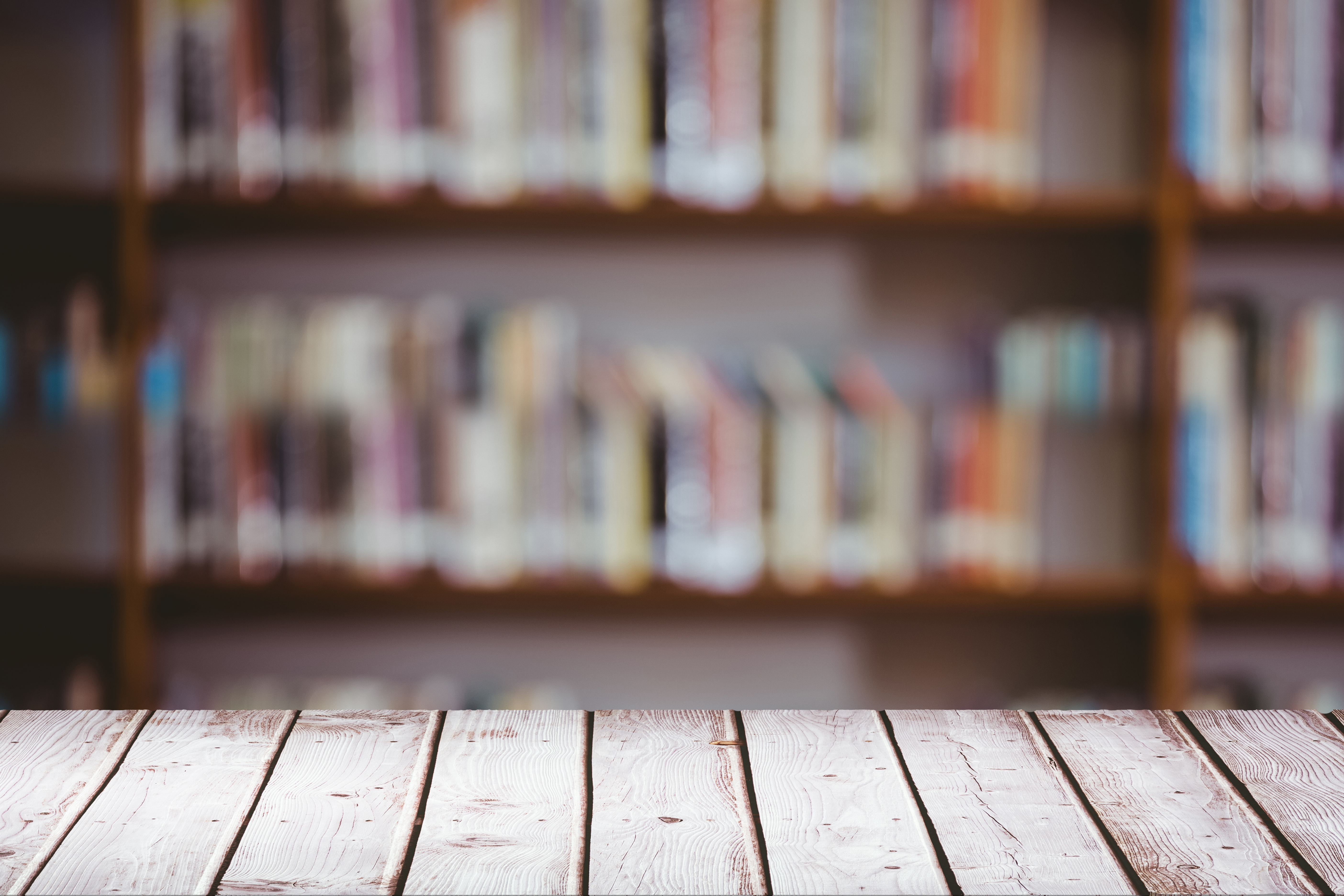 digital composite of Wooden table with library background